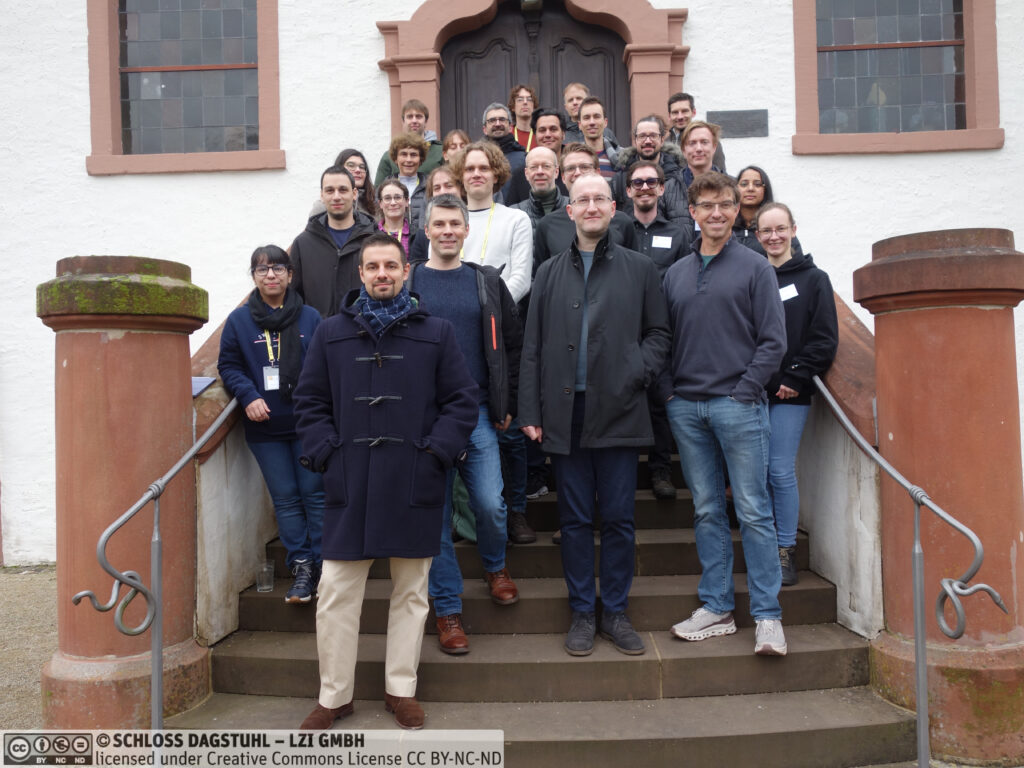 Photo of the participants of Dagstuhl seminar 26042 standing on the stairs of Schloss Dagstuhl.